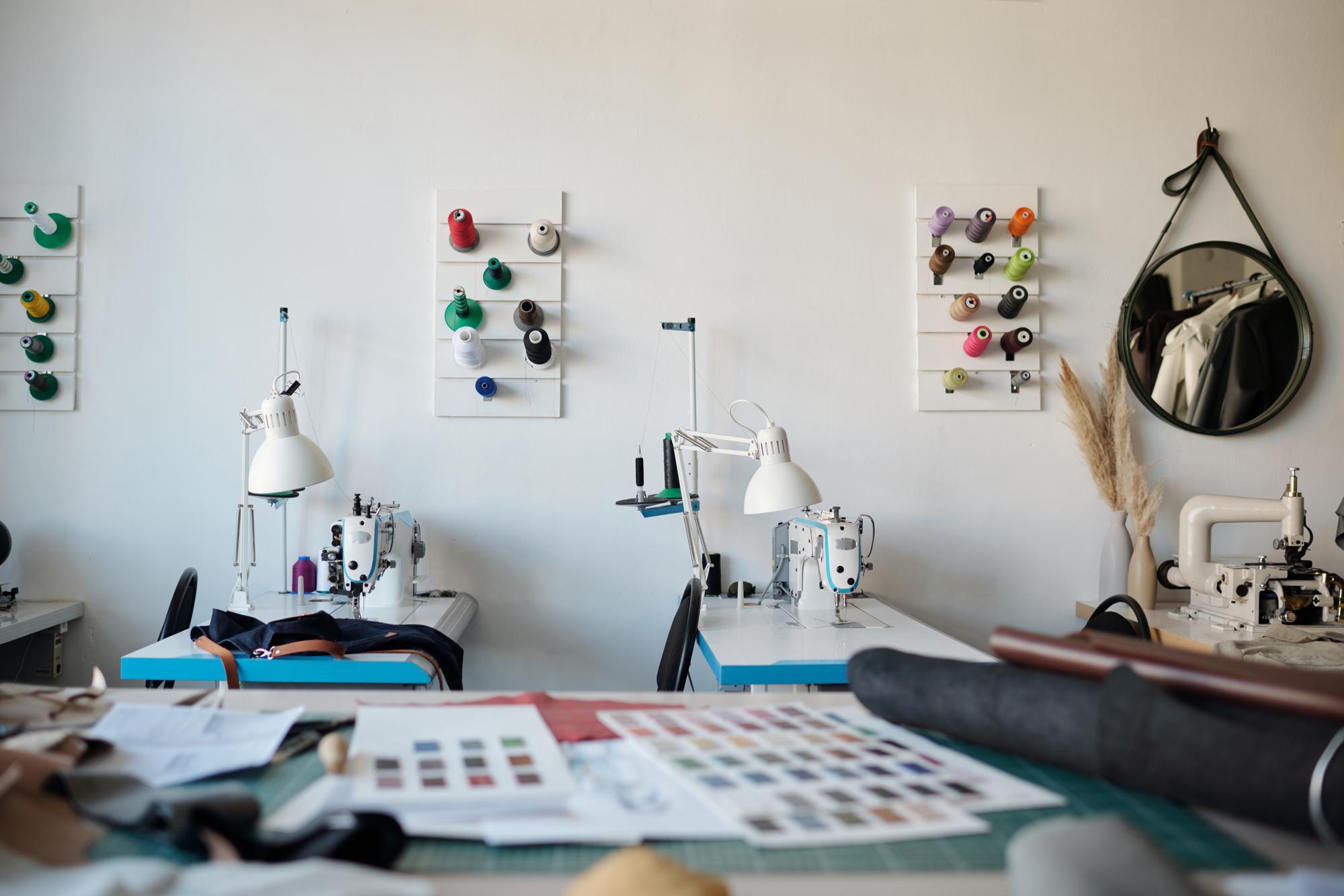 studio workspace with sewing machine and threads